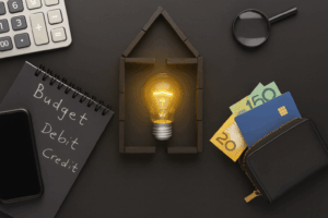 Borrowing Power Calculator Australia – Home Loan Budget and Affordability Concept | Find A Better Rate Home Loans Flat lay showing Australian dollar notes, calculator, wallet and house lightbulb concept for borrowing power calculator and home loan affordability in Australia