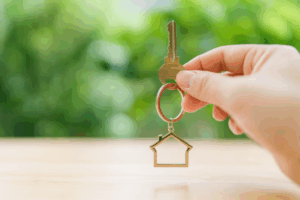 Hand holding house key keyring symbolising home loan approval with Find A Better Rate mortgage brokers Australia