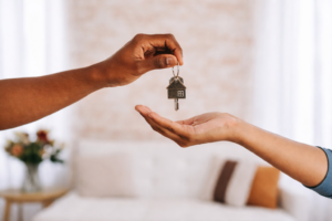 First-time home buyer receiving house keys while learning how to find the best mortgage rates in Australia