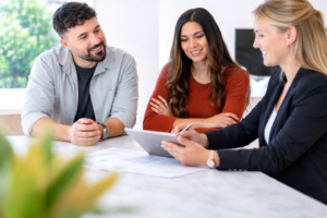 Finance broker in Melbourne assisting a couple with loan options during a finance consultation