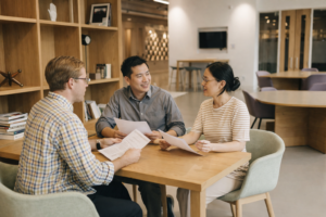 Mortgage advisor meeting with clients to review home loan options in a modern Australian office